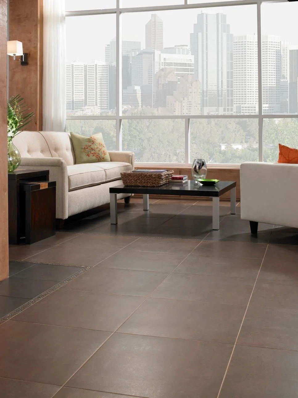 Large-format dark gray porcelain floor tiles in a modern urban living room